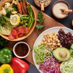 Vegan protein source. Buddha bowl dish, avocado, pepper, tomato, cucumber, red cabbage, chickpea, fresh lettuce salad and walnuts, nuts, beans, . Healthy vegetarian eating, super food. Top view.