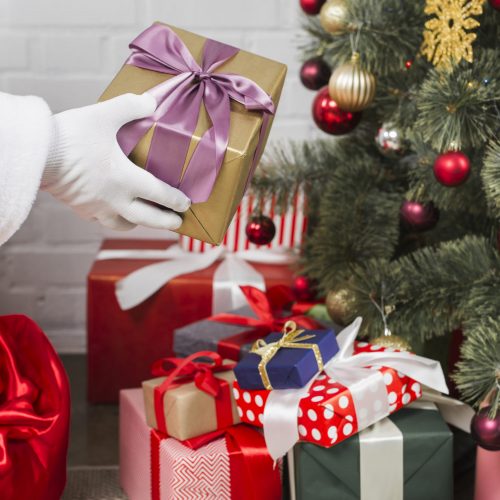 santa-putting-gift-boxes-christmas-tree